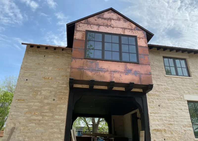 Copper metal panel facade on a stone building for Skylight Installation in Eldorado at Santa Fe